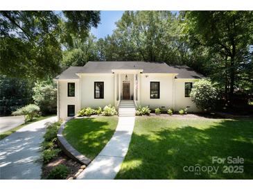 Charming white brick home featuring a well-manicured lawn and elegant front entrance at 1408 Rinehart Ct, Charlotte, NC 28270