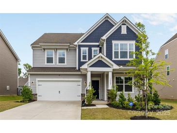 Charming two-story home featuring a two-car garage, well-manicured lawn, and inviting front entrance at 14407 Cardwell Hill Ln, Charlotte, NC 28278