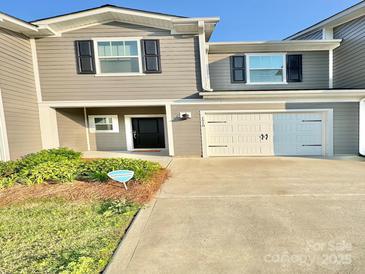 Charming home featuring a grey exterior, black shutters, and a well-maintained lawn at 1510 Old Rivers Rd # 171, Concord, NC 28027