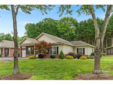 Charming single-story home with manicured lawn and mature trees at 2561 26Th Ne Ave, Hickory, NC 28601