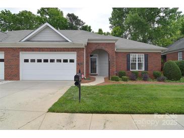 Charming brick home featuring a two-car garage and a well-manicured lawn at 3814 Misty Glen Ct, Matthews, NC 28105