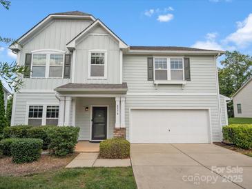 Charming two-story home featuring light blue siding, a two-car garage, and well-manicured landscaping at 4576 Fox Ridge Ln, Fort Mill, SC 29707