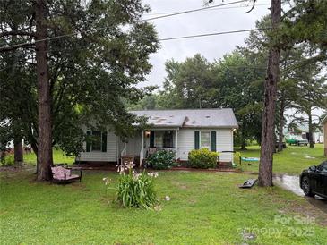 Charming single-story home featuring a well-manicured lawn and mature trees at 508 Hillcrest St, Marshville, NC 28103