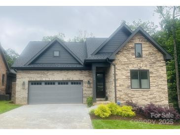 Charming single-Gathering home boasting a stone and brick facade, a gray roof, and a well-manicured lawn at 5100 Silver Trace Ln, Denver, NC 28037