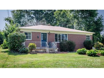 Charming brick home features a well-manicured lawn and landscaping at 616 26Th Nw St, Hickory, NC 28601