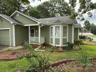 Charming single-story home with green siding, white trim, landscaped yard, and covered front porch at 6300 Fox Hunt Rd, Indian Trail, NC 28079