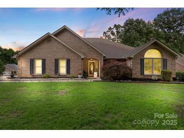 Charming brick home with well-manicured lawn and inviting entrance with an American flag at 800 Isle Of Palms Ct, Fort Mill, SC 29708