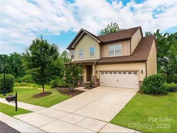 Charming two-story home featuring a manicured lawn and a spacious two-car garage at 15416 Oleander Dr, Charlotte, NC 28278