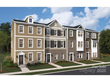 Charming new construction townhome featuring brick and siding exterior and well-manicured front yard at 1940 Westerhill Dr, Fort Mill, SC 29708