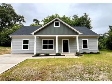 Charming gray home featuring a covered front porch with stately columns and a well-manicured lawn at 212 Queens Ct, Gastonia, NC 28052