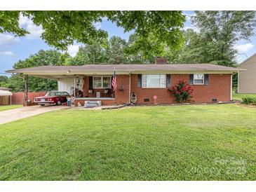 Charming brick home with a well-manicured lawn, classic car, and inviting front porch at 2210 Joes Lake Rd, Shelby, NC 28152