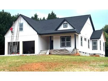 New construction home featuring white siding, dark roof, covered porch and an attached two car garage at 2589 Polo Ln, Maiden, NC 28650