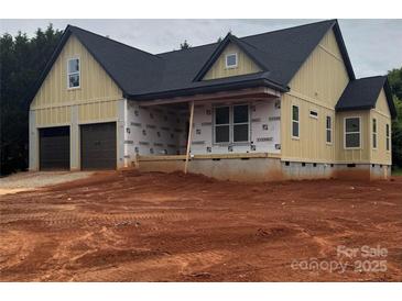 New construction exterior with a two-car garage and covered porch, showcasing modern design and quality craftsmanship at 2589 Polo Ln, Maiden, NC 28650