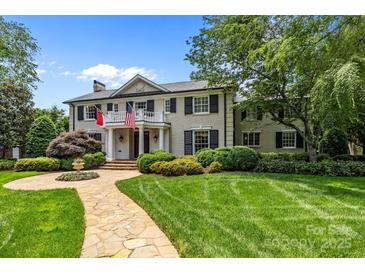 Charming two-story home featuring manicured landscaping and a stone walkway leading to the front entrance at 640 Colville Rd, Charlotte, NC 28207