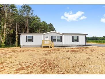 Inviting home with a classic design, featuring a well-manicured lawn at 977 Myers Mill Rd, Olin, NC 28660