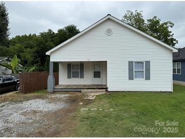 Charming single-story home with white siding, gray shutters, and a small front porch at 303 Southern Ave, East Spencer, NC 28039