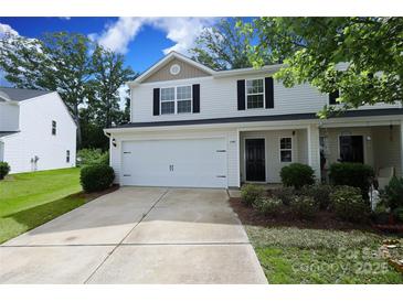 Two-story home with a white exterior, black shutters, an attached garage, and a well-manicured front lawn at 3349 Ellingford Rd, Charlotte, NC 28214