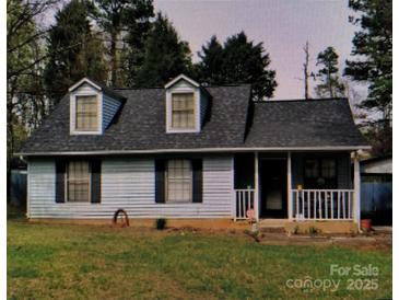 Charming home featuring dormer windows, light siding, and a welcoming front porch at 5816 Rocky Mount Ct, Charlotte, NC 28214