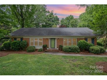 Charming brick home with a well-manicured lawn and mature trees at 5926 Sharon Rd, Charlotte, NC 28210