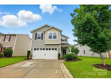 Charming two-story home featuring a two-car garage, well-maintained lawn, and lovely landscaping at 9733 Paper Tree Rd, Charlotte, NC 28227