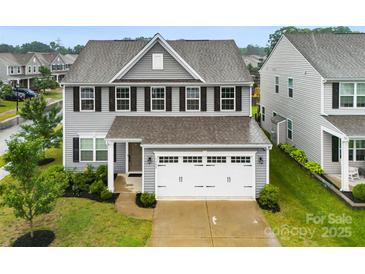 Charming two-story home features a manicured lawn and a two-car garage at 1022 Hinson Forest Rd, Monroe, NC 28110