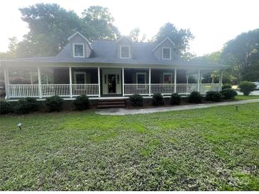 Charming brick home featuring a spacious front porch, dormer windows, and well-manicured lawn at 1619 Bellamy Cir, Albemarle, NC 28001
