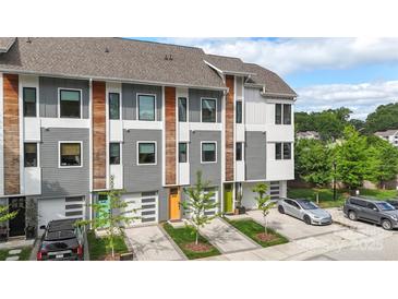 View of newly constructed townhomes featuring modern architecture, individual garages, and colorful front doors at 2653 Shenandoah Ave, Charlotte, NC 28205