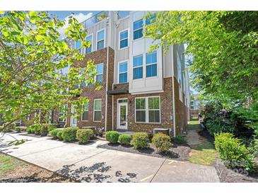 Modern townhome with brick facade, white accents, tidy landscaping, and visible balcony at 420 E 16Th St, Charlotte, NC 28206