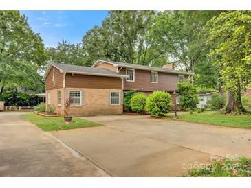 Inviting two-story home with brick and wood panel exterior and an extended driveway at 841 12Th Nw Ave, Hickory, NC 28601