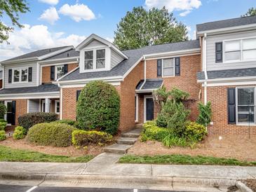 Charming brick townhome with well-maintained landscaping and a welcoming entrance at 9121 Kings Canyon Dr, Charlotte, NC 28210