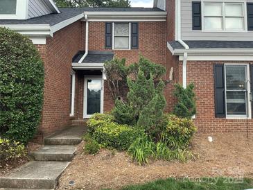 Charming brick home with a welcoming front entrance and beautifully landscaped garden in a well-kept neighborhood at 9121 Kings Canyon Dr, Charlotte, NC 28210
