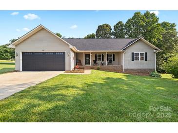 Charming single-story home with a well-manicured lawn and welcoming front porch at 105 Saddlewood Ln, Statesville, NC 28625