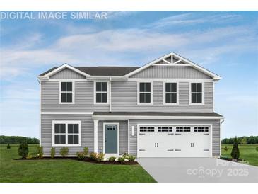 Charming two-story home featuring gray siding, white trim, a blue front door and an attached two-car garage at 12105 Beaux Art Ln, Charlotte, NC 28214