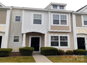 Charming townhouse with neutral siding and a well-maintained front yard at 13441 Calloway Glen Dr, Charlotte, NC 28273