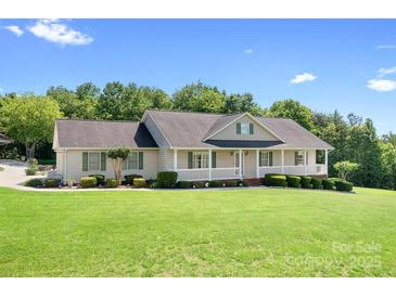 Charming single-story home featuring a welcoming front porch and beautifully landscaped front yard at 136 Barringer Dr, Statesville, NC 28625