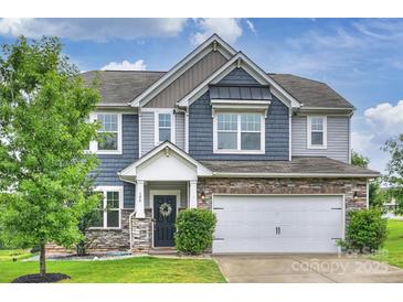 Charming two-story home with a two-car garage, stone accents, and well-maintained landscaping at 198 Wrangell Dr, Mooresville, NC 28117