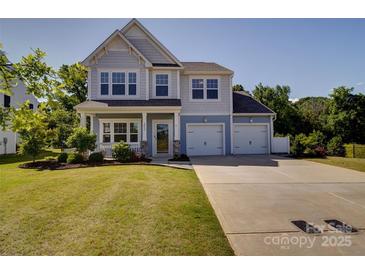 Charming two-story home with a well-manicured lawn and a spacious two-car garage at 2035 Beacon Ave, Monroe, NC 28110