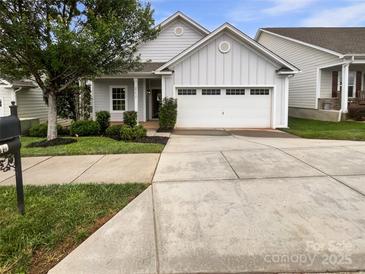 Charming one-story home featuring a light gray exterior, well-manicured landscaping, and an attached two-car garage at 27415 Cinderella Cir, Lancaster, SC 29720