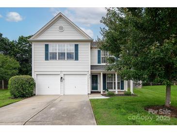Charming two-story home with a well-maintained lawn and a two-car garage at 5741 Bentgrass Run Dr, Charlotte, NC 28269