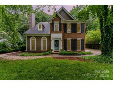 Charming brick home with black shutters and lush green lawn at 8624 Canter Post Dr, Charlotte, NC 28216