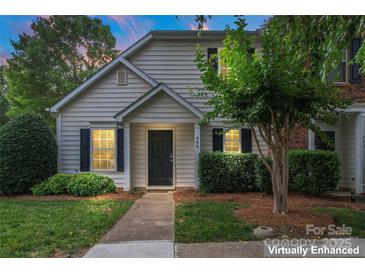 Charming home featuring a well-maintained lawn, a black door, and tasteful shrubbery at 945 Heritage Pkwy, Fort Mill, SC 29715