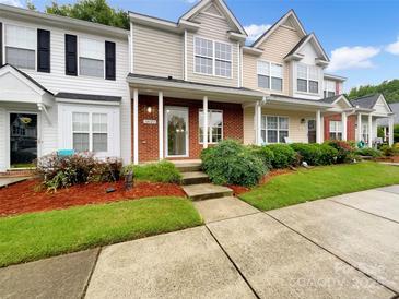 Charming townhouse showcasing well-manicured lawn and inviting front porch at 14123 Tranters Creek Ln, Charlotte, NC 28273