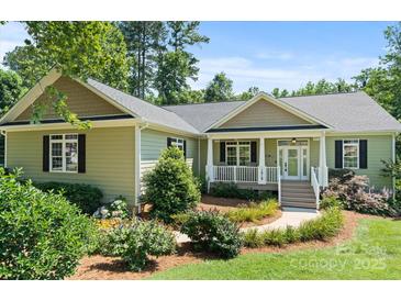 Charming home featuring a covered front porch, manicured landscaping, and a well-maintained lawn at 1819 Brompton Ct, Newton, NC 28658