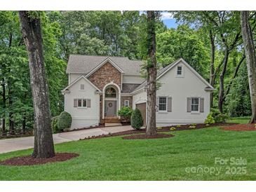 Stunning two-story home with stone accents, landscaped yard, and a charming entrance at 20312 Deep Cove Ct, Cornelius, NC 28031