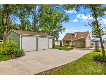 Charming home featuring a detached two-car garage, a covered carport, and lush landscaping at 270 Yachtsman Dr, Salisbury, NC 28146