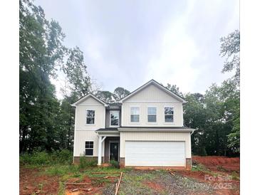 Charming two-story home features a large garage and classic architectural details, nestled amid lush trees at 3248 Killian Rd, Lincolnton, NC 28092