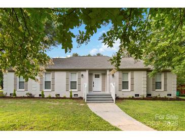 Charming single-story home featuring a brick facade, landscaped front yard and a welcoming front entrance at 3801 Rea Rd, Charlotte, NC 28226