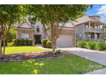 Charming home featuring a stone and vinyl exterior, well-manicured lawn, and a two-car garage at 4121 Cedar Point Ave # 28, Stallings, NC 28104