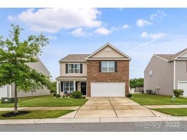 Charming two-story home with a brick and siding exterior, well-manicured lawn, and an inviting front porch at 515 Benford Ln, Stanley, NC 28164