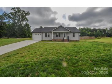 Charming single-story home with a well-manicured lawn, attached garage, and inviting front porch at 108 Devynne Ct, Salisbury, NC 28146